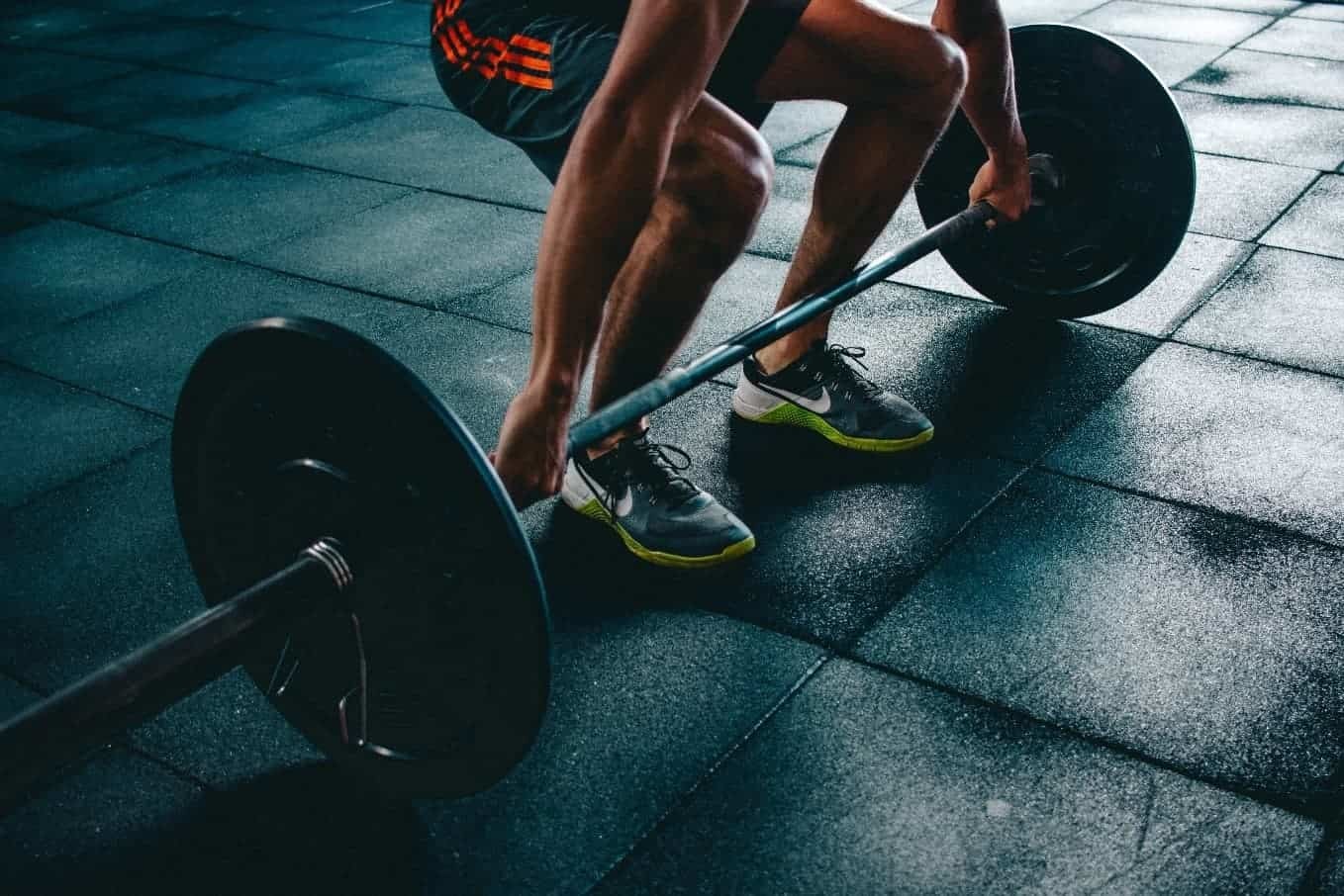 how to stretch tight hamstrings - holding barbell