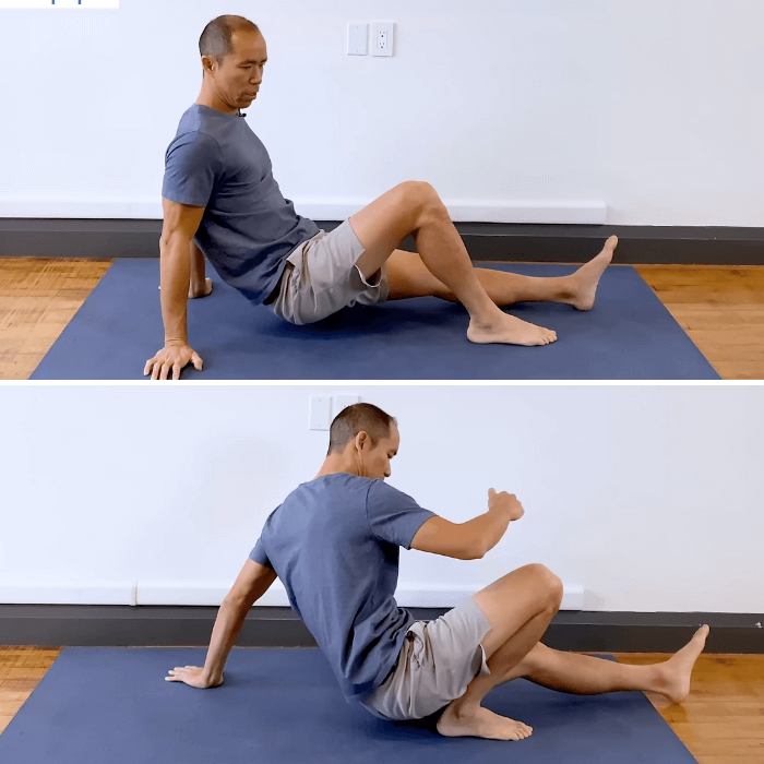 Person sitting barefoot on the floor with one foot flat, lifting hips and pulling forward with planted foot and hamstring to train deep knee flexion and ankle dorsiflexion.