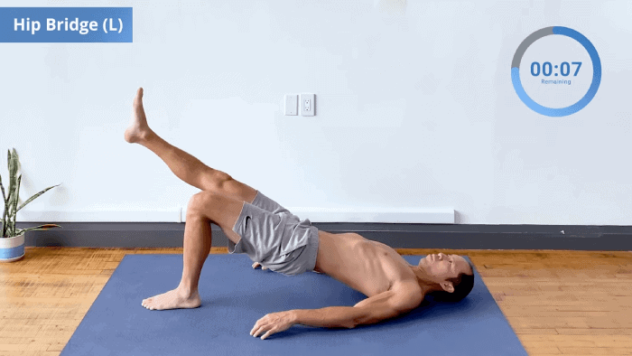 Single-leg glute bridge with left foot on the ground, hips raised, and right leg extended.