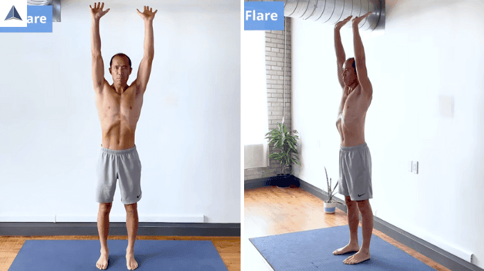 Arms overhead with extended wrists and fingers flared, reaching upward.